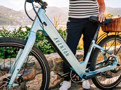 man-proudly-standing-by-his-aventon-pace-4-casual-cruiser-step-thru-ebike